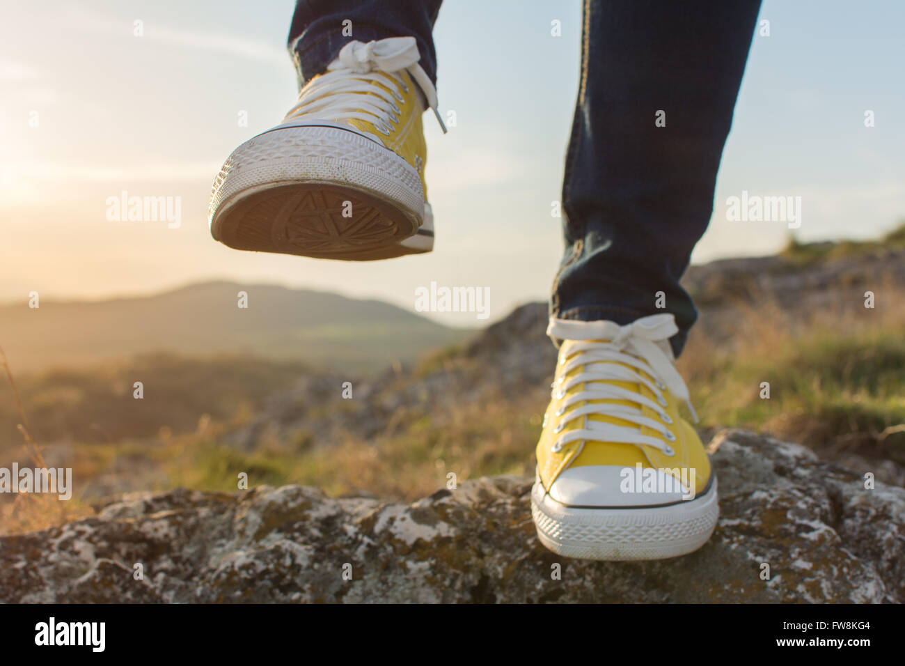 Woman on a hiking trip with close up at yellow sneakers Stock Photo