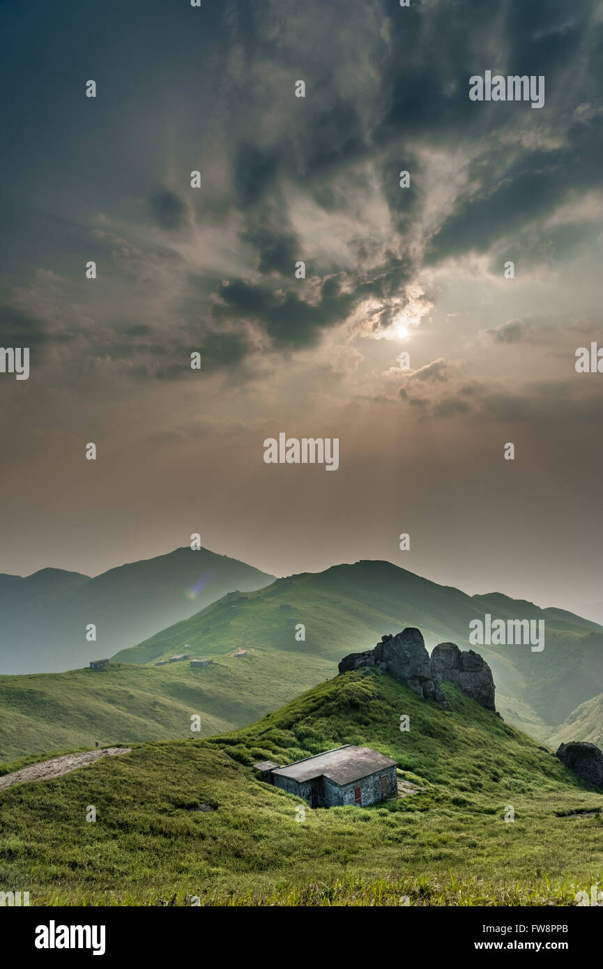 Sun rise in mountain with a house in front Stock Photo