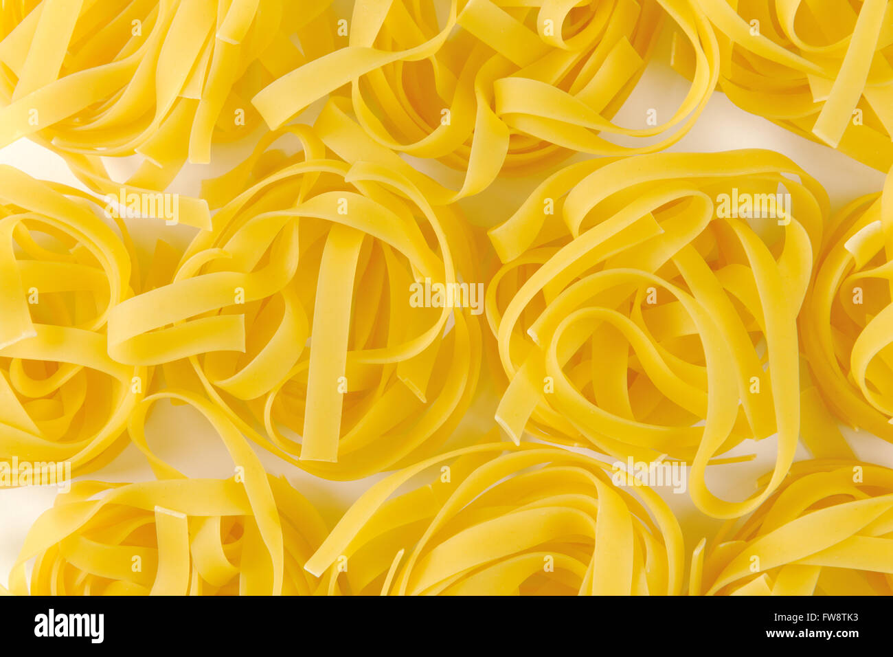 Dried ribbons of pasta coiled into nests Stock Photo Alamy
