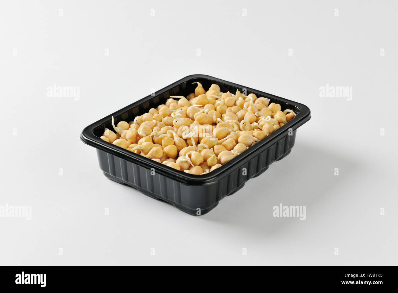 Sprouted chickpeas black plastic food container Stock Photo