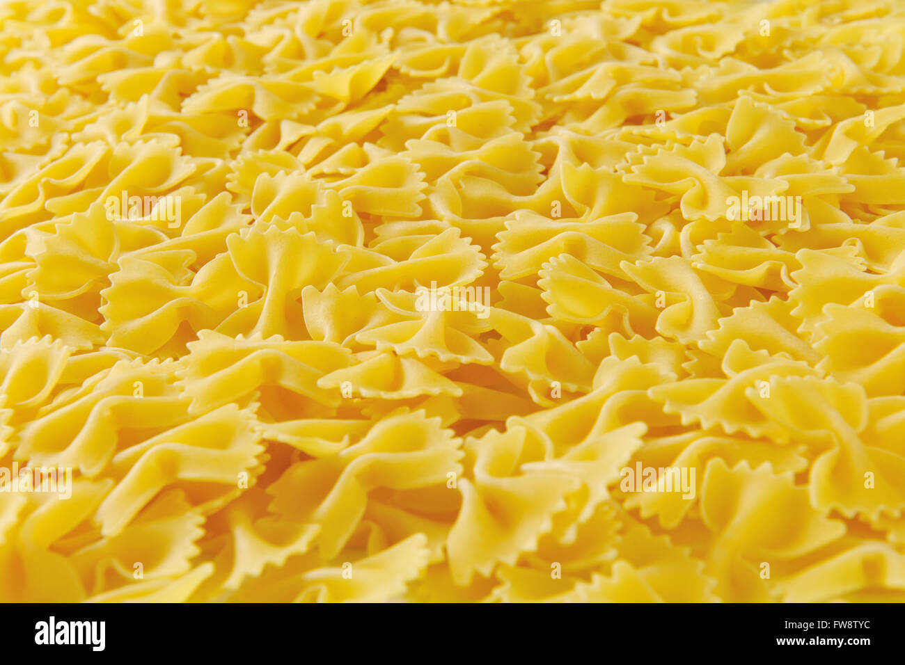 Background of uncooked bow tie pasta Stock Photo - Alamy