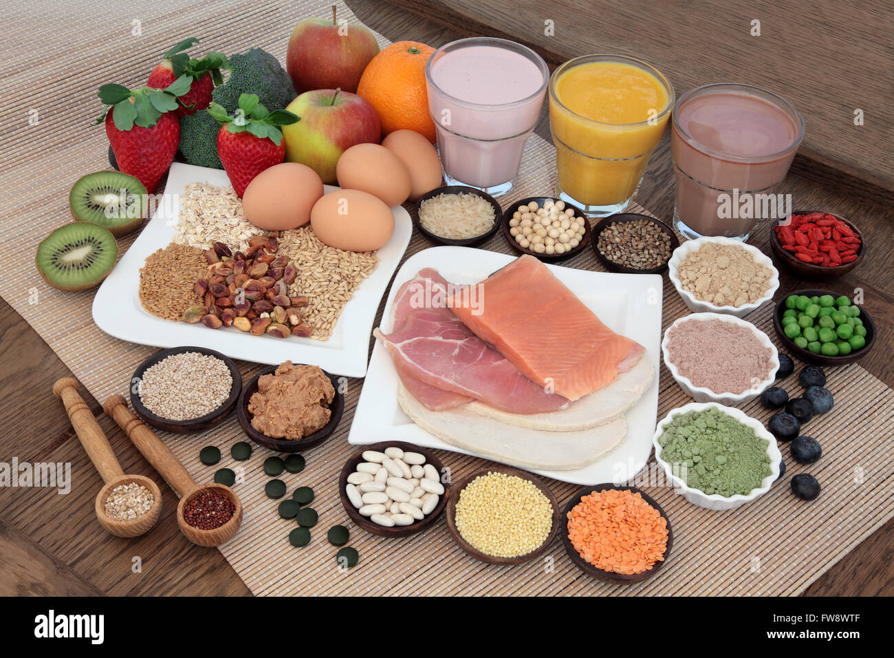 Health and body building food with fish and meat, supplement powders, vitamin tablets, veg, fruit and juice smoothie shakes. Stock Photo