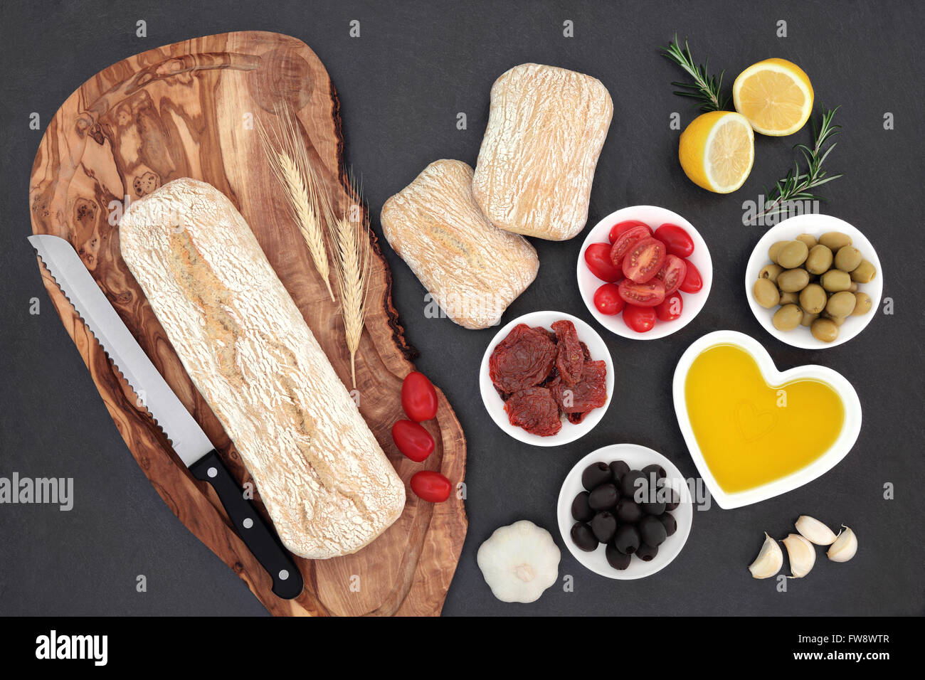 Mediterranean food with olives, fresh and sun dried tomatoes, garlic