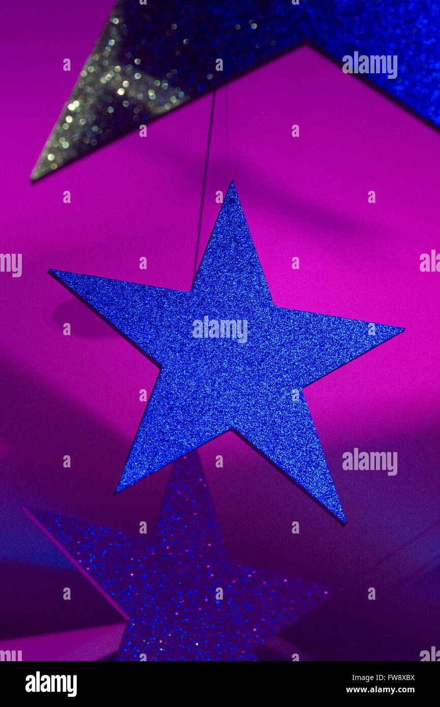 Large Stars Covered In Glitter Hang From The Ceiling Of An Event