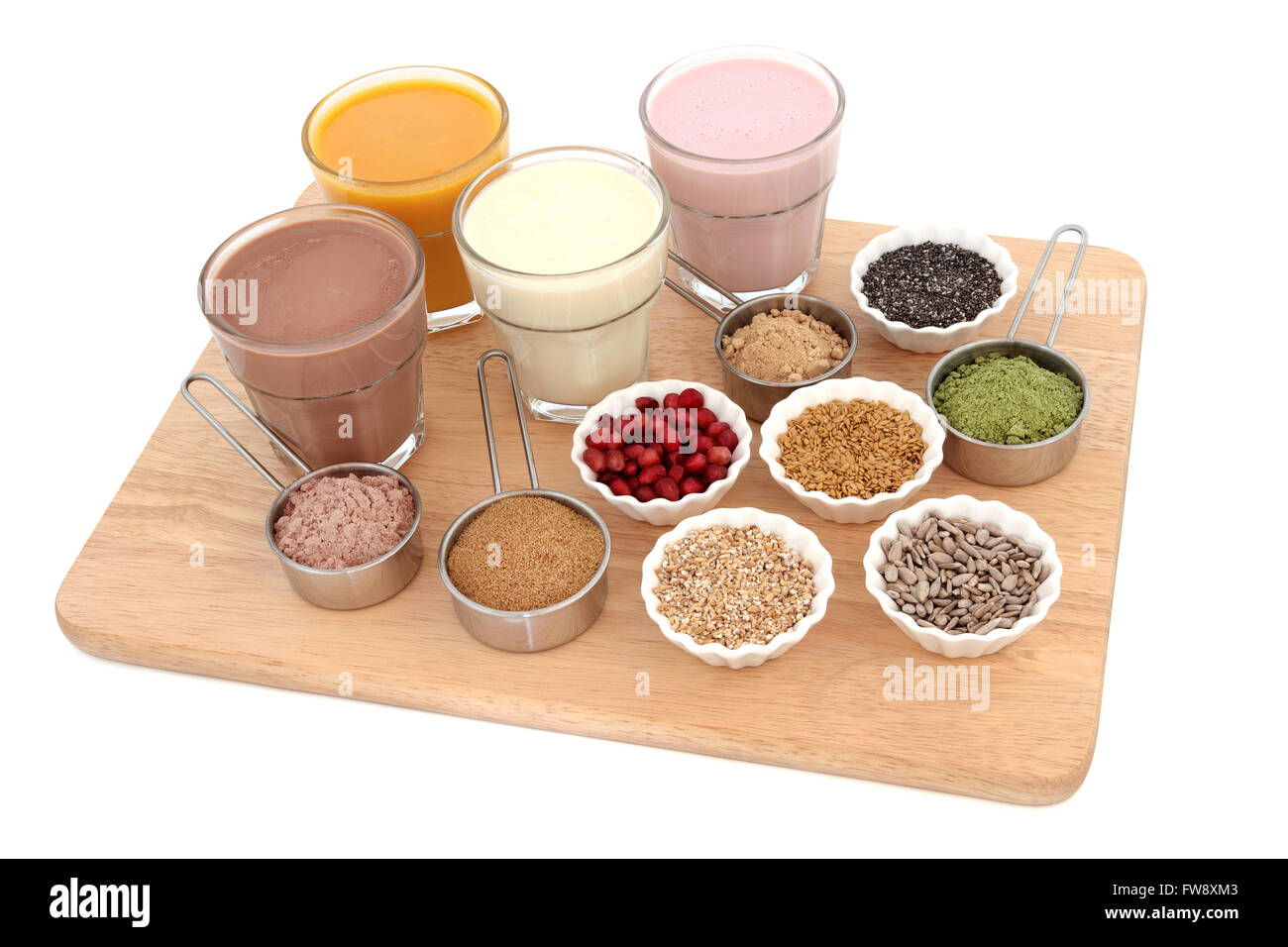 Body building health food with protein and fruit juice shakes, chocolate whey, wheat grass, pomegranate and maca powder. Stock Photo