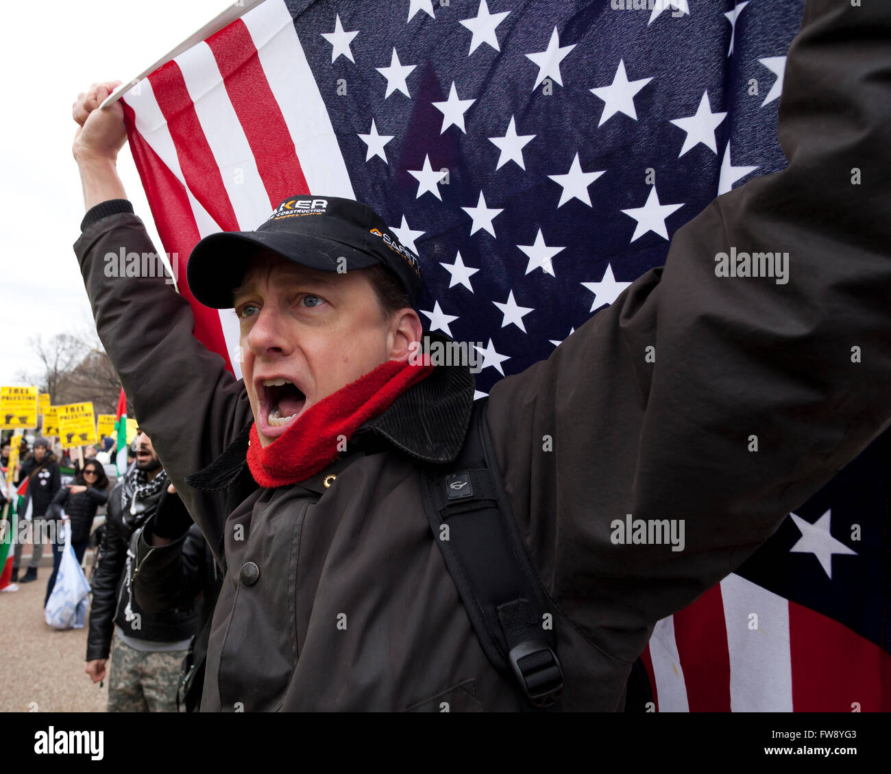 Man holding up American flag at political protest rally - Washington, DC USA Stock Photo
