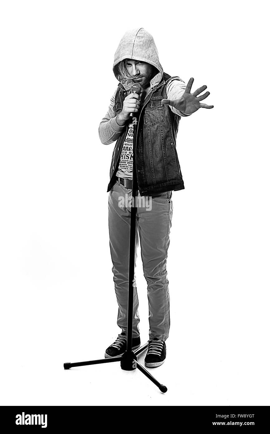 black and white photo of a man singing with microphone isolated on white background, a nice young man with blond hair singing wi Stock Photo
