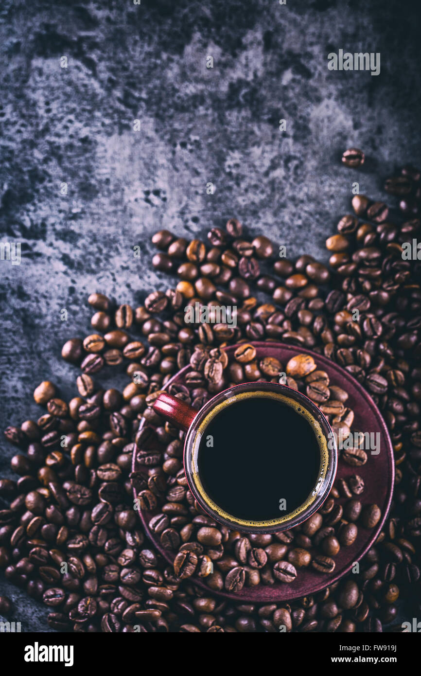 Coffee. Cup of black coffee and spilled coffee beans. Coffee break. Stock Photo