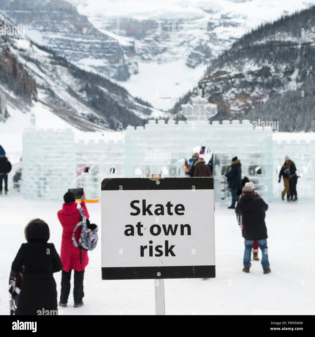Warning signboard with people at ski resort, Lake Louise, Banff National Park, Alberta, Canada Stock Photo