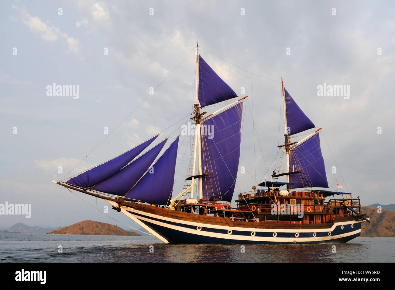 Sailboat with hoisted sails, Indonesia Stock Photo