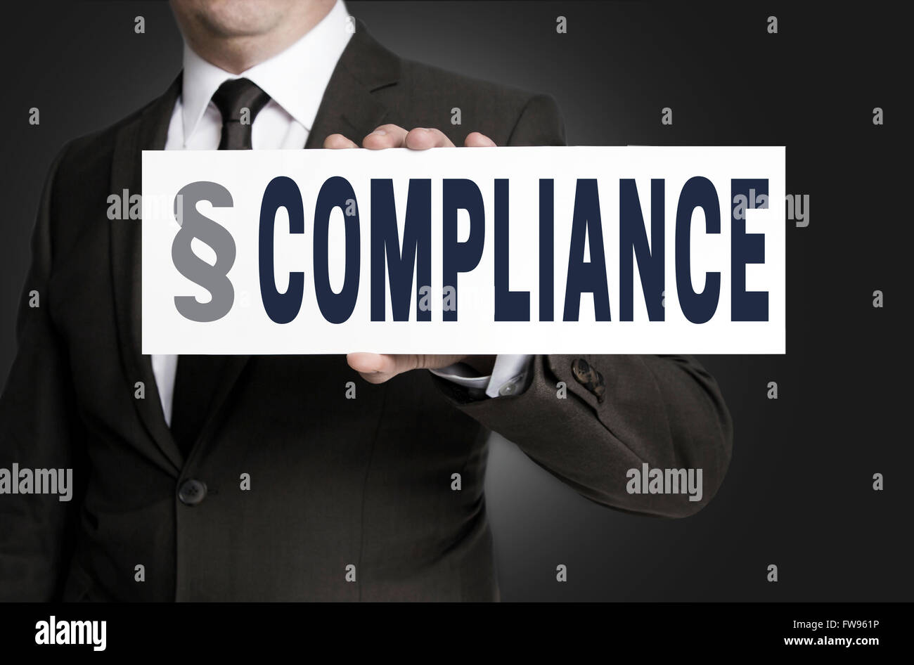 compliance placard is held by businessman. Stock Photo
