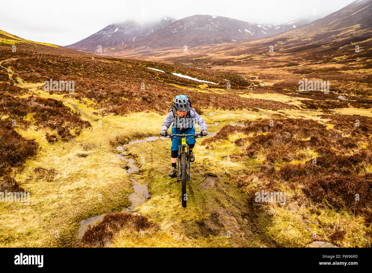 Mountain biker on remote moorland in Cairngorms National Park east of Blair Atholl Perthshire Scotland Stock Photo