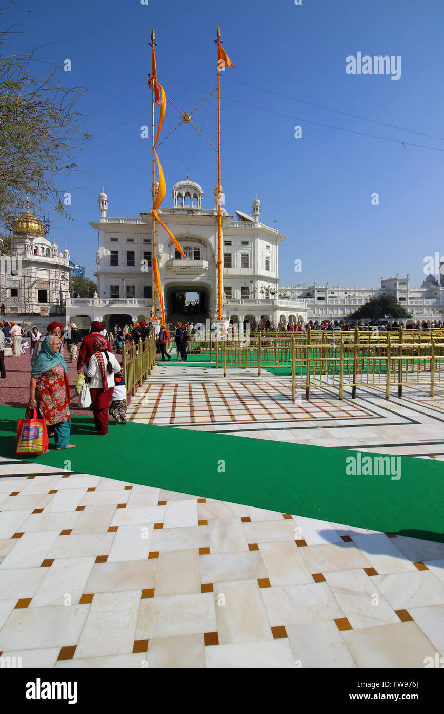 Pilgrims visiting the Golden Temple at Amritsar on a beautiful blue sky day. Stock Photo