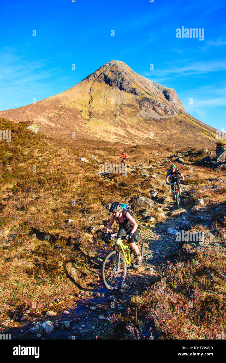 Mountain bikers on the trail from Camasunary to Sligachan Isle of Skye Scotland with Marsco behind. Stock Photo