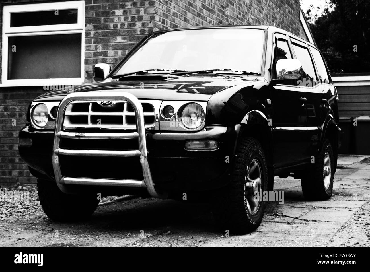 1997 black Ford Maverick 2.7 TDI GLS 5 door with an after market bullbar on a driveway in the UK. Stock Photo