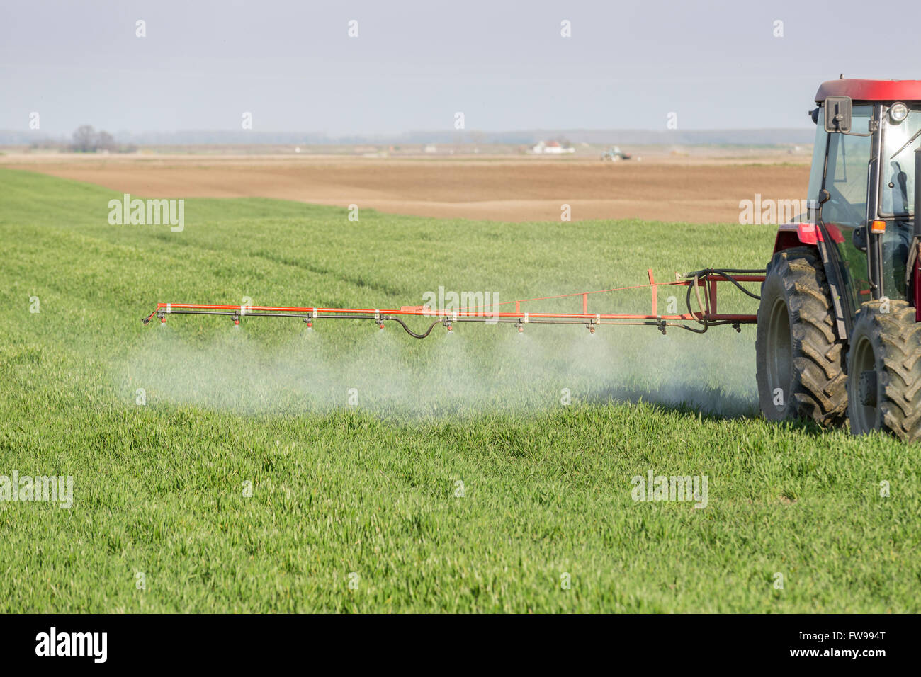 Farmer spraying green wheat field Stock Photo Alamy