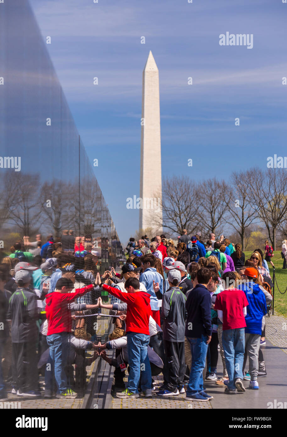 WASHINGTON, DC, USA - Crowd gathers at Vietnam War Memorial, and Washington Monument. Stock Photo