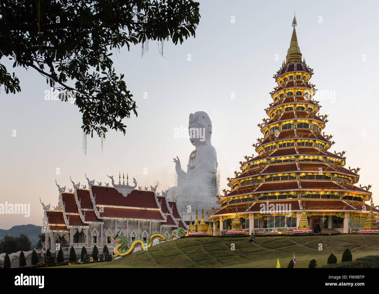 Illuminated Wat Huay Pla Kang temple at dusk with gigantic Guan Yin statue, Kuan Yin, Chiang Rai Province, Northern Thailand Stock Photo