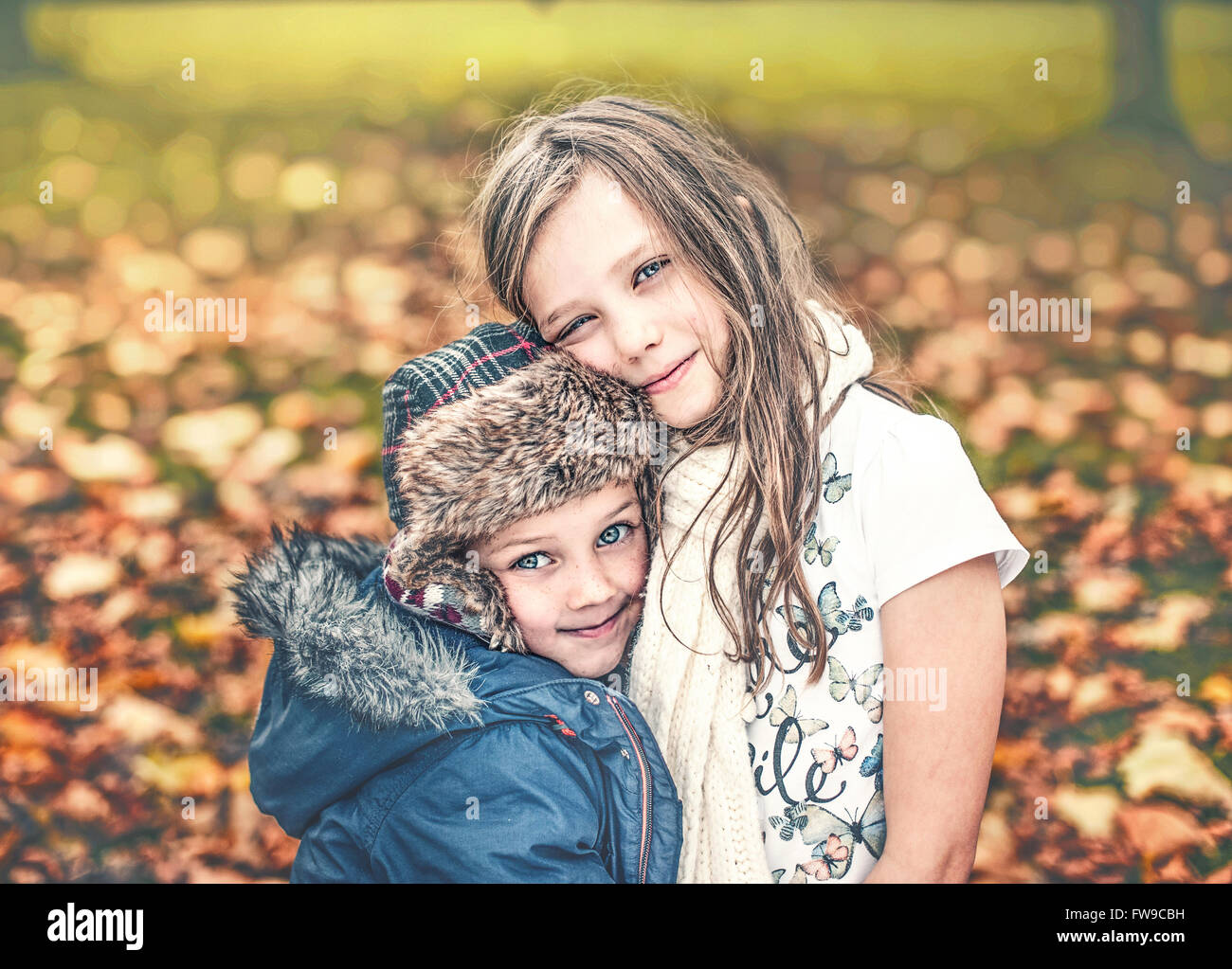 brother and sister holding each other in autumn park Stock Photo - Alamy