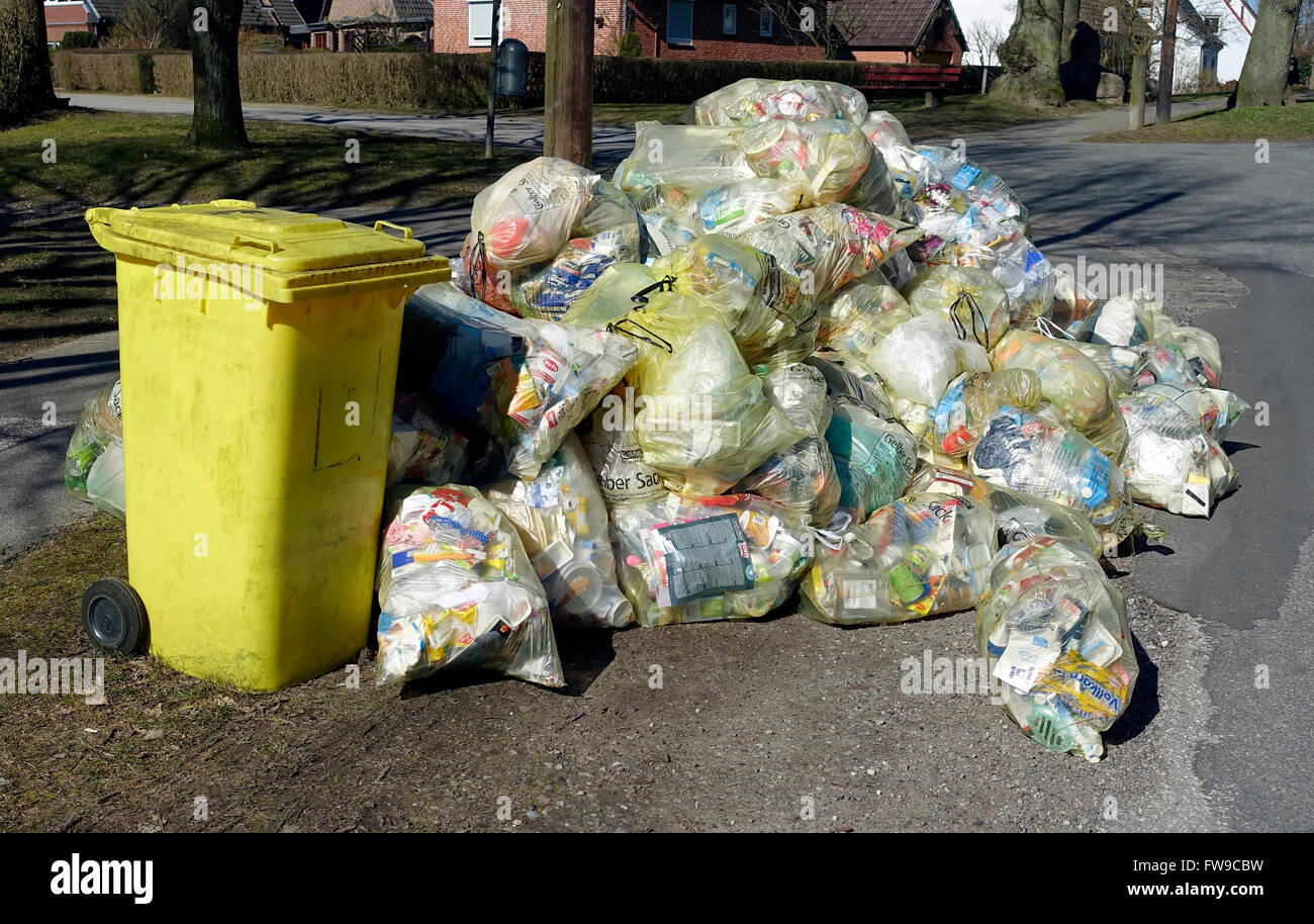 Accumulation of garbage bags, recycling sacks, yellow bags, ready to be picked, Kiel-Oppendorf, Schleswig-Holstein, Germany Stock Photo