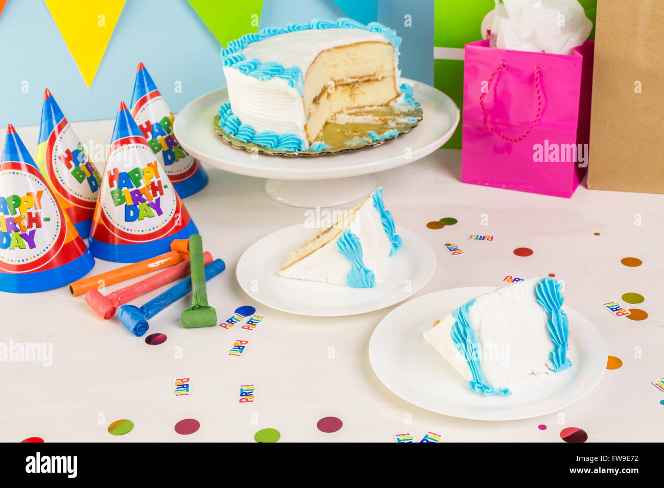 Simple white Birthday cake slice with white and blue icing Stock Photo