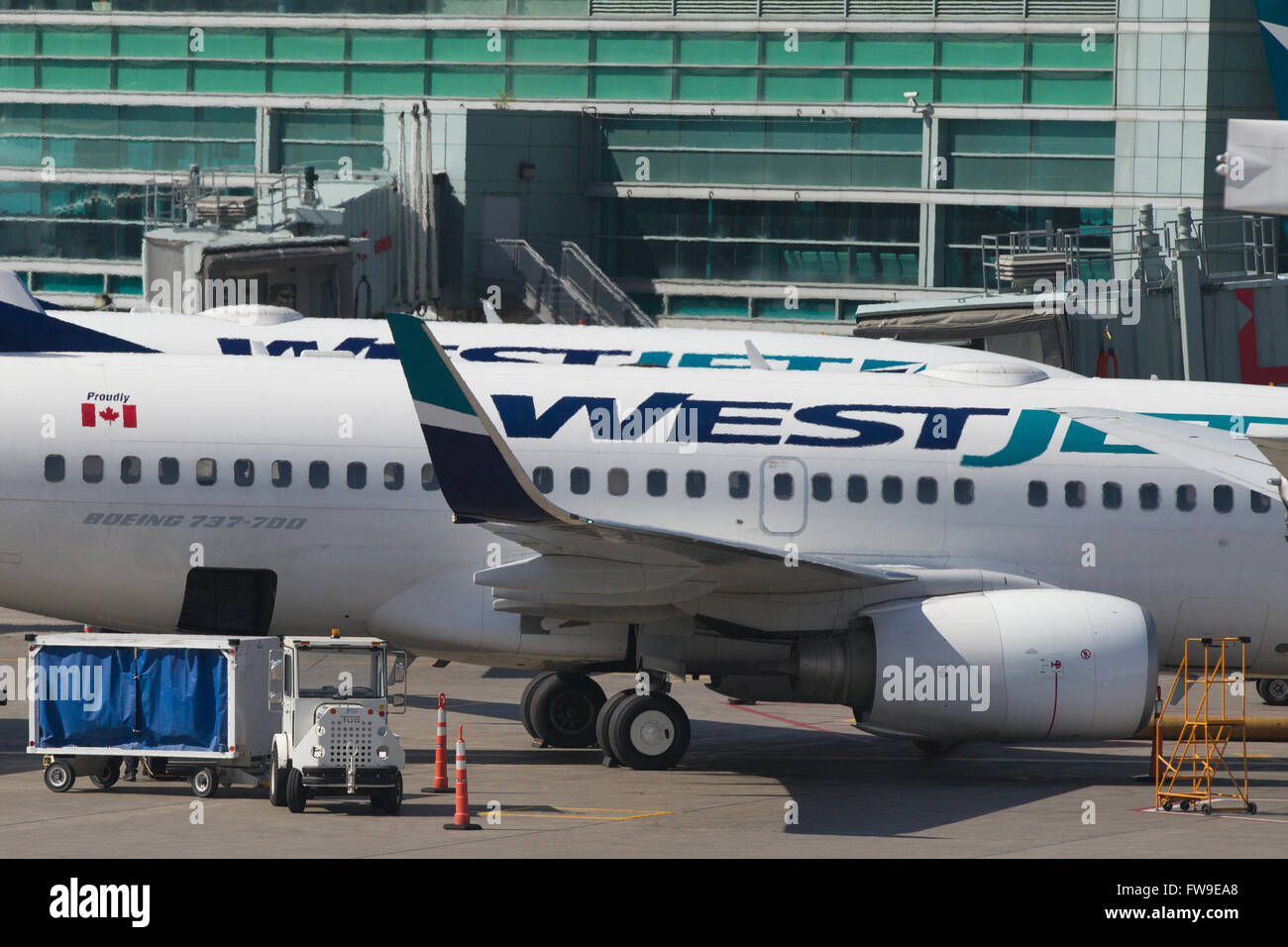 A Westjet aircraft waits to be loaded before departing from Pearson International airport in Toronto, Ontario on May 7, 2015. Stock Photo