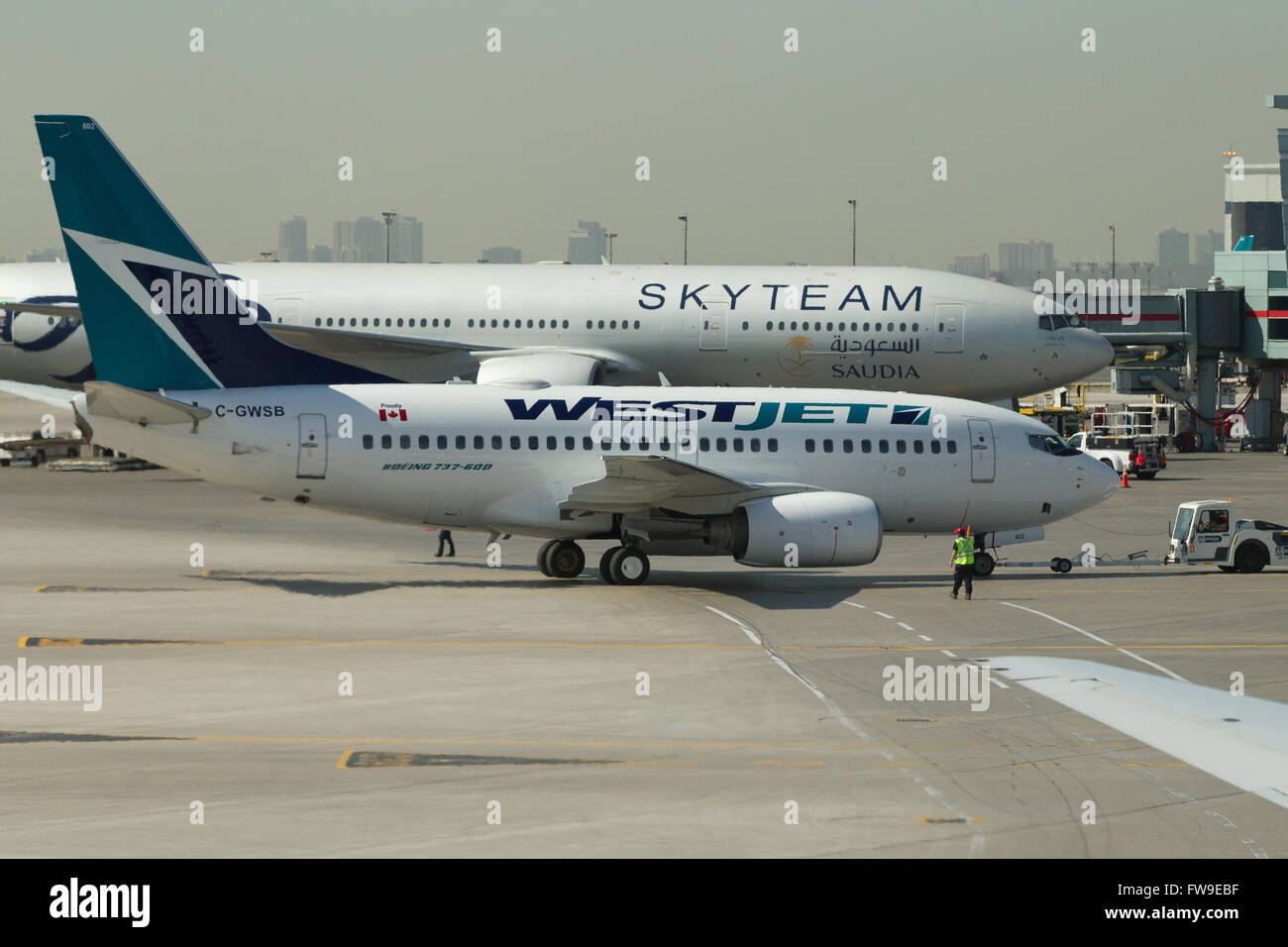 A Westjet aircraft waits to be loaded before departing from Pearson International airport in Toronto, Ontario on May 7, 2015. Stock Photo