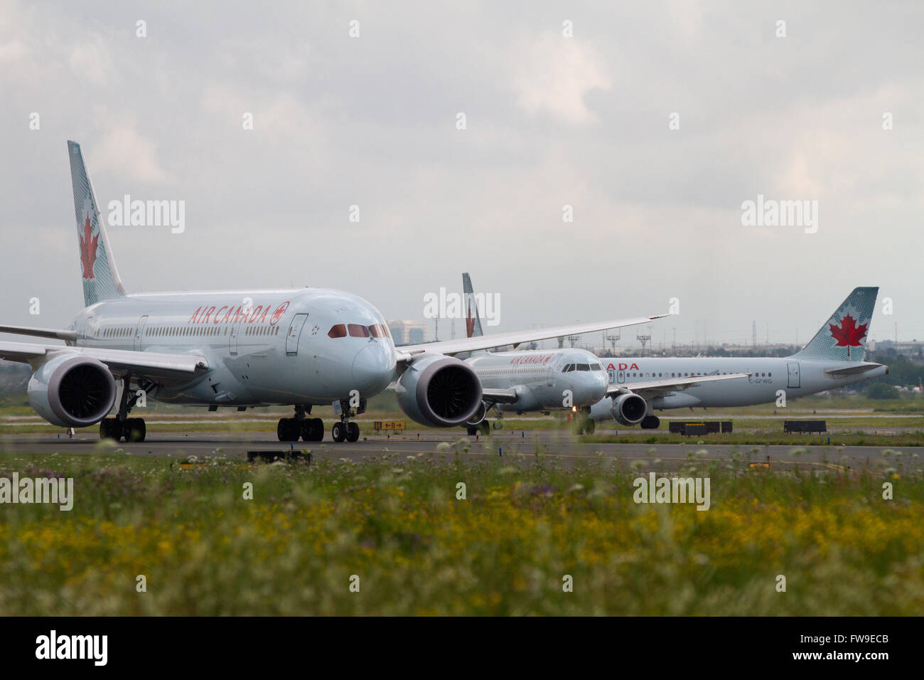 Three Air Canada jets taxi on the tarmac at Pearson International