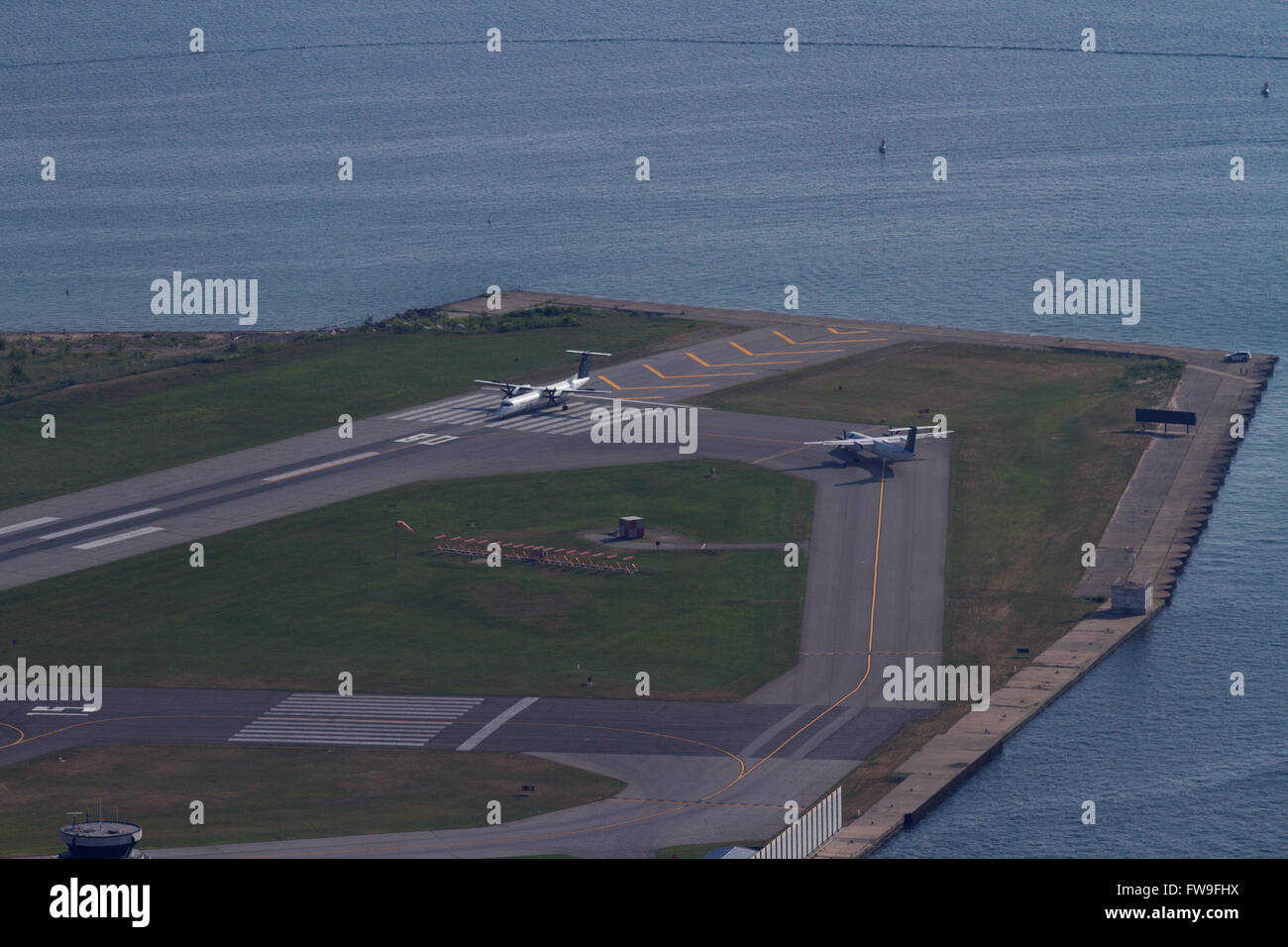 Two planes stand on the tarmac at Billy Bishop Toronto Island airport waiting to take off in Toronto Ont., on Wednesday Jul. 29, Stock Photo