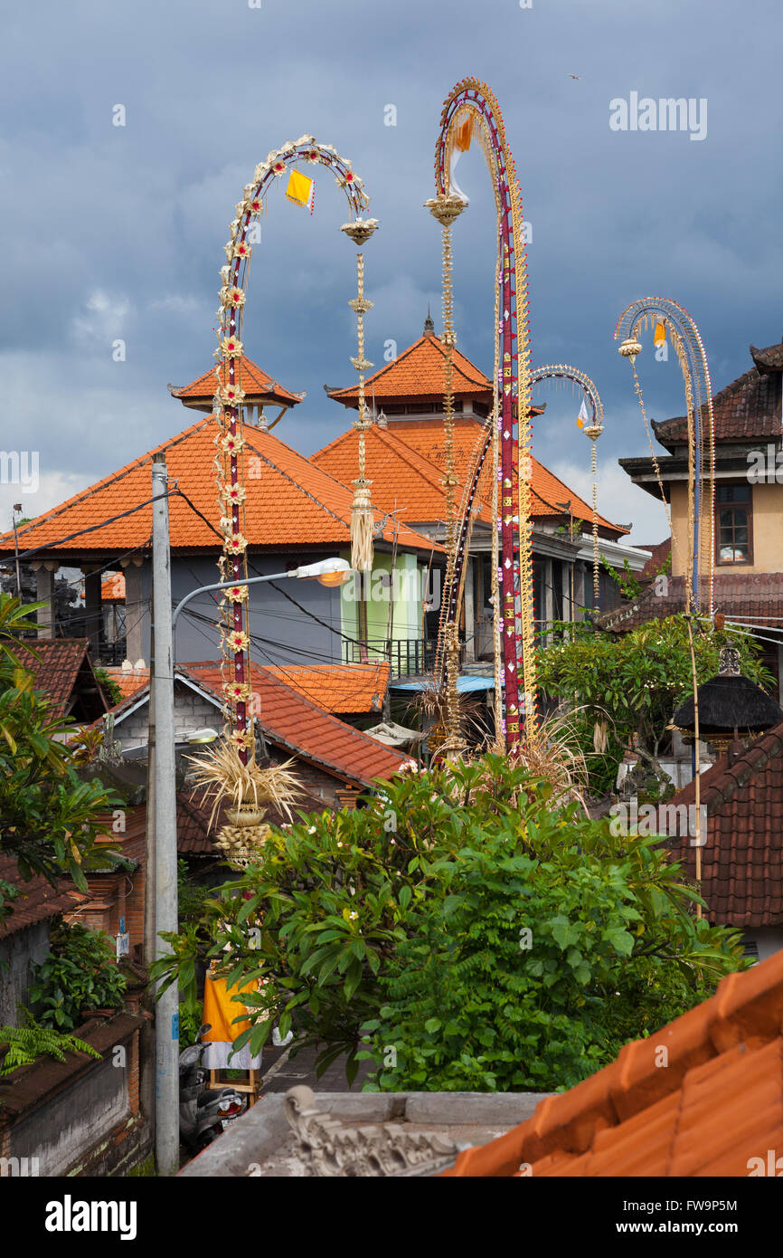 Traditional balinese roofs and ceremonial bamboo decorations on the street during celebrations of Nyepi, Day of Silence or Balin Stock Photo