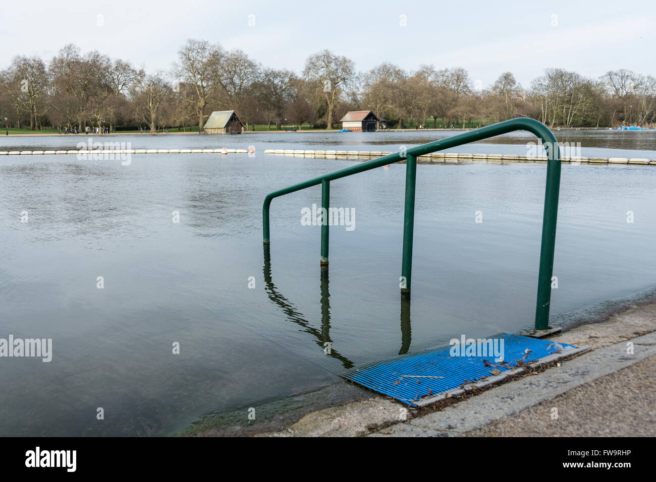 Railings on a placid Serpentine, Hyde Park central London, England, UK Stock Photo