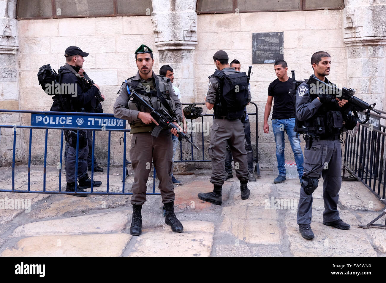 Armed Israeli security forces check young Palestinian man at the Old ...