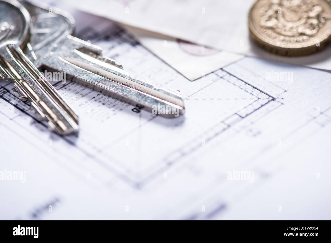key for new house on architect drawings and coins Stock Photo Alamy