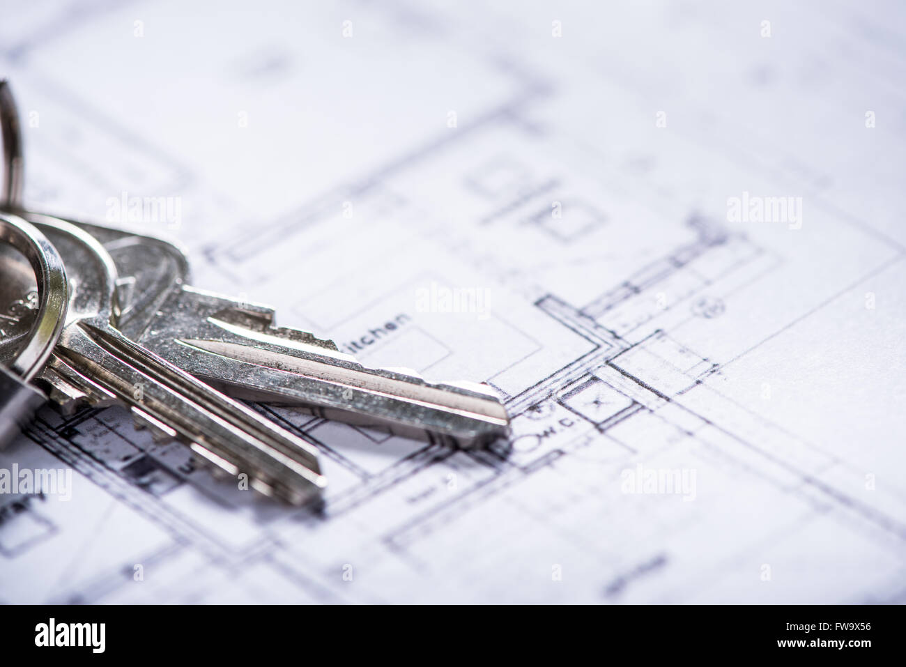 key for new house on architect drawings , estate agent concept Stock Photo Alamy
