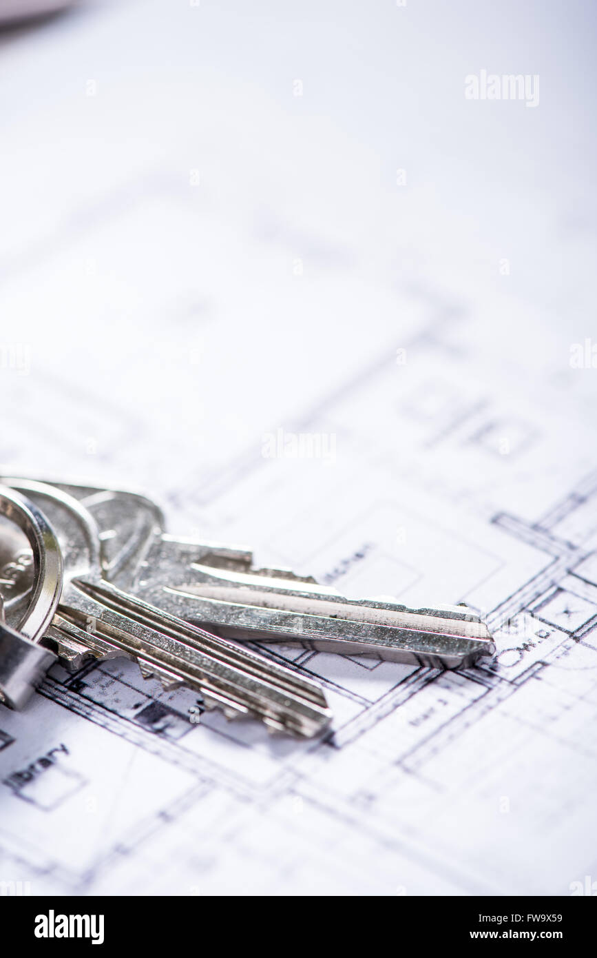 key for new house on architect drawings , estate agent concept Stock Photo Alamy
