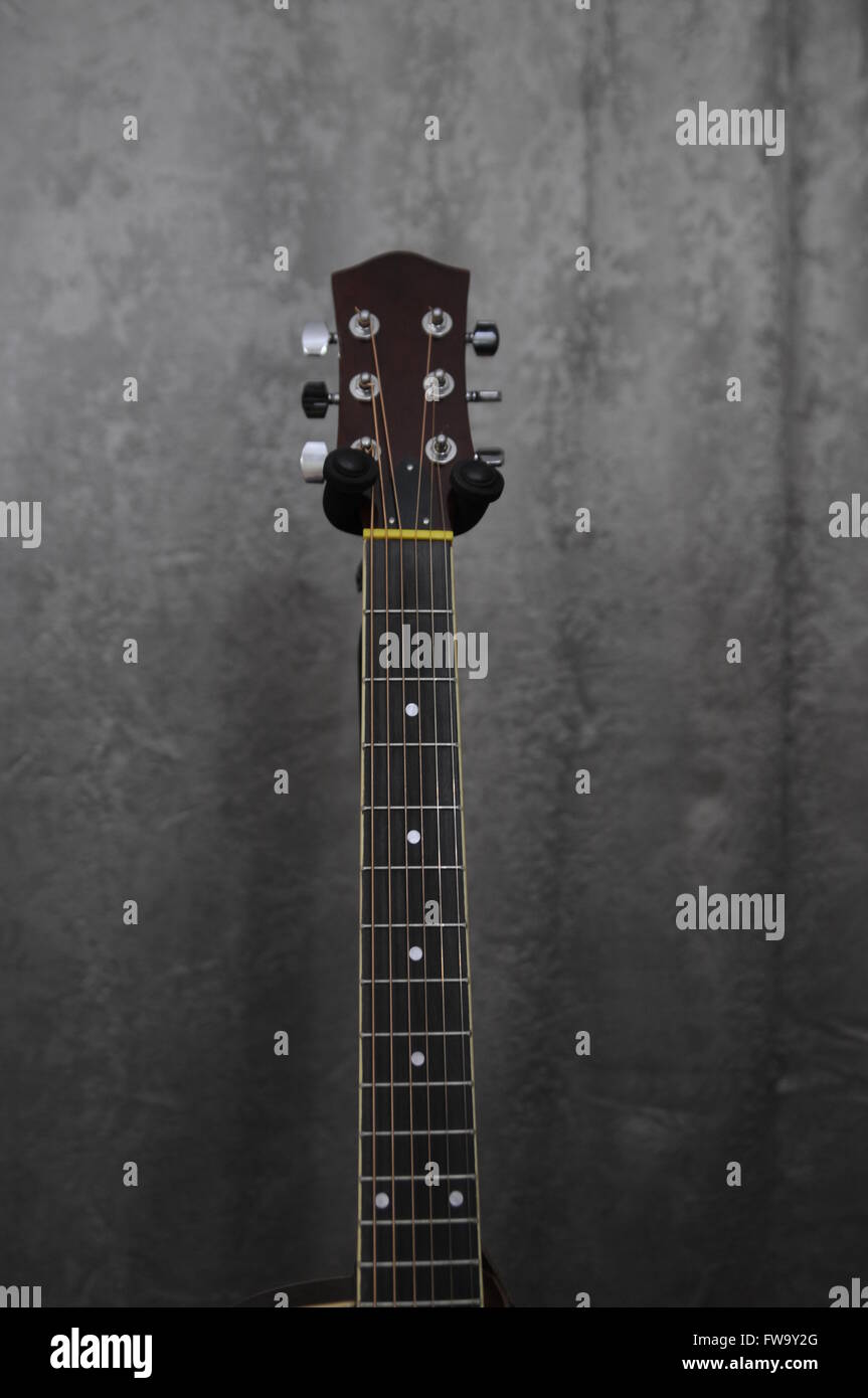 Guitar neck against gray background Stock Photo