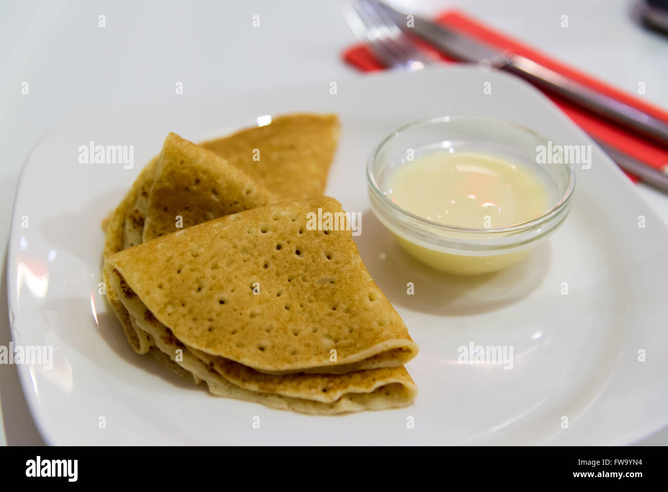 Pancakes with condensed milk on  plate Stock Photo