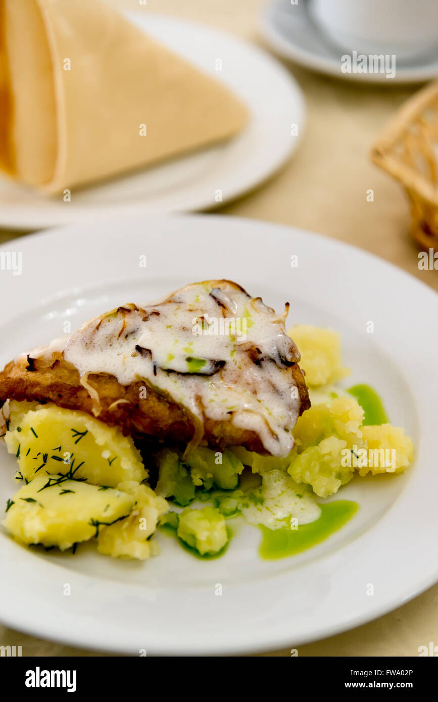 Boiled potatoes and cod in batter Stock Photo Alamy