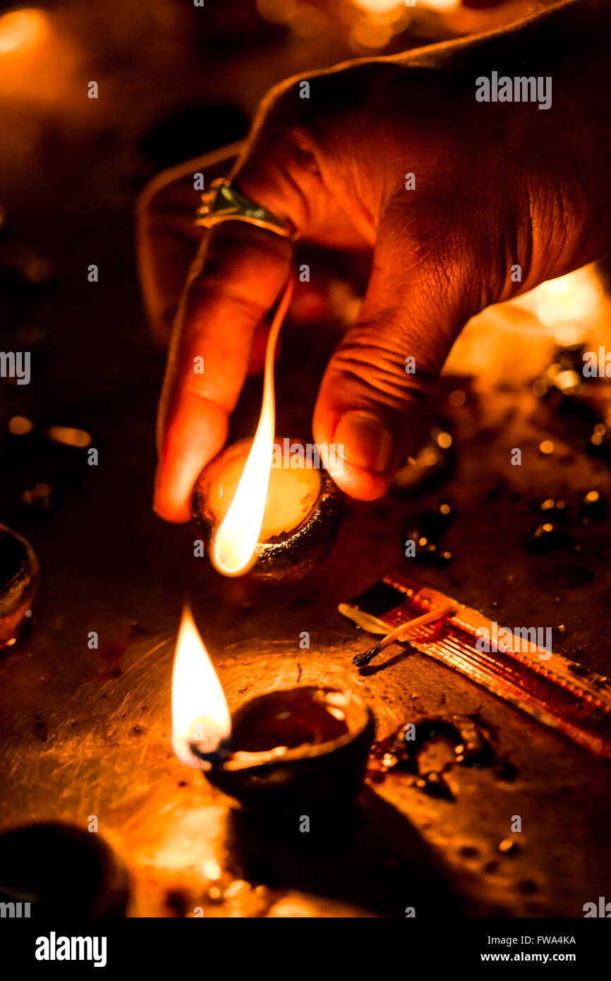 Burning candles in the Indian temple. Diwali the festival of lights. Warning - authentic shooting with high iso in challenging l Stock Photo
