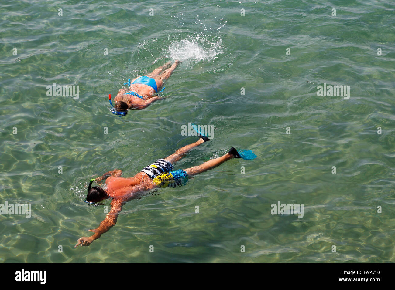 Couple snorkeling in transparent water Stock Photo