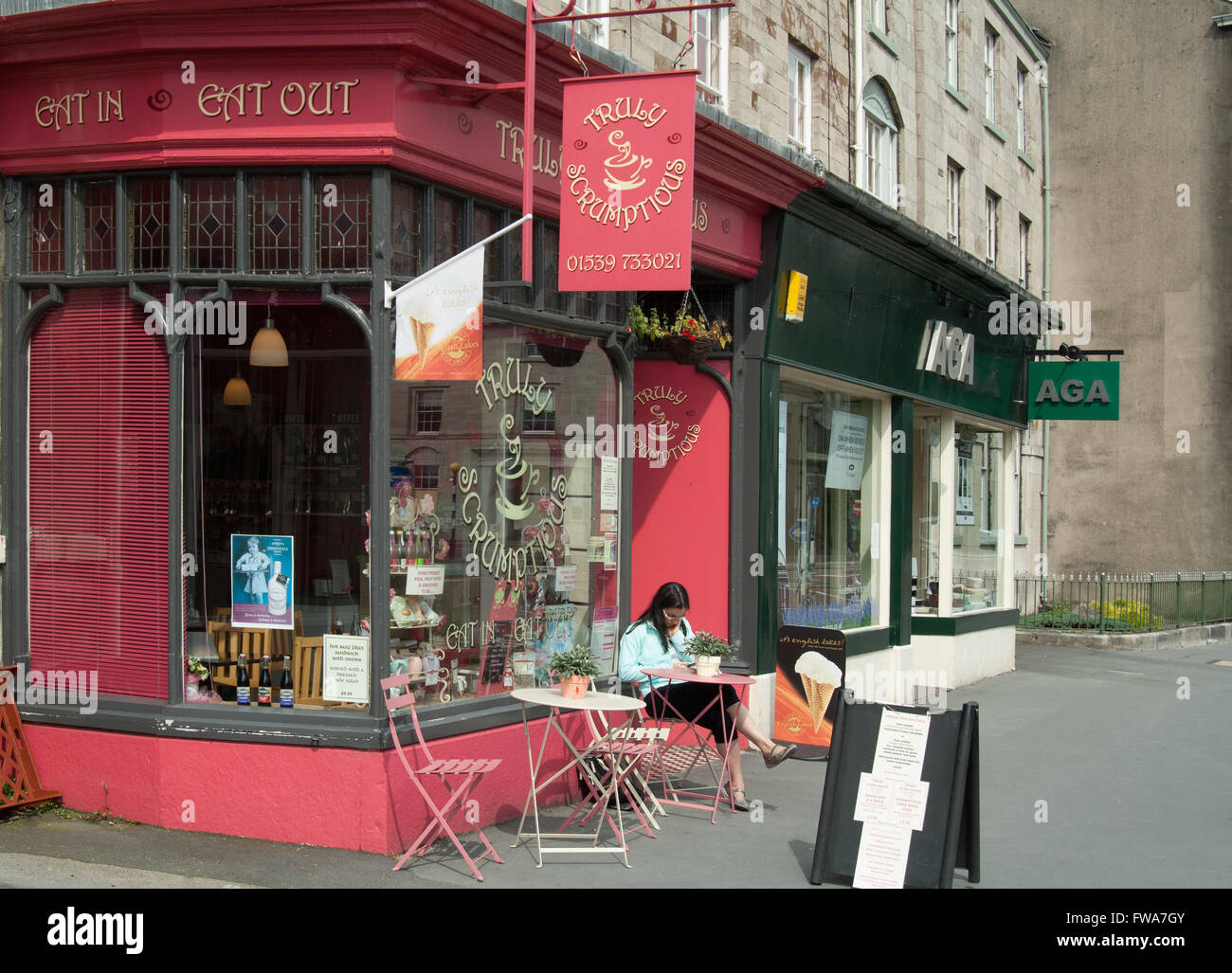 Cafe, with Lady sitting outside. Kendal, town. Stock Photo
