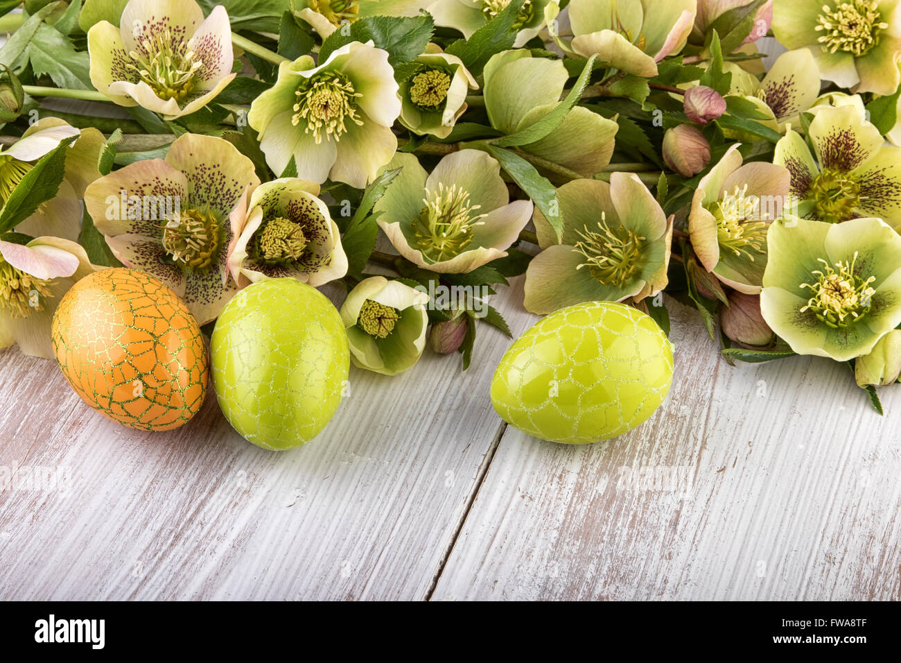 Yellow green flowers with Easter Eggs Stock Photo