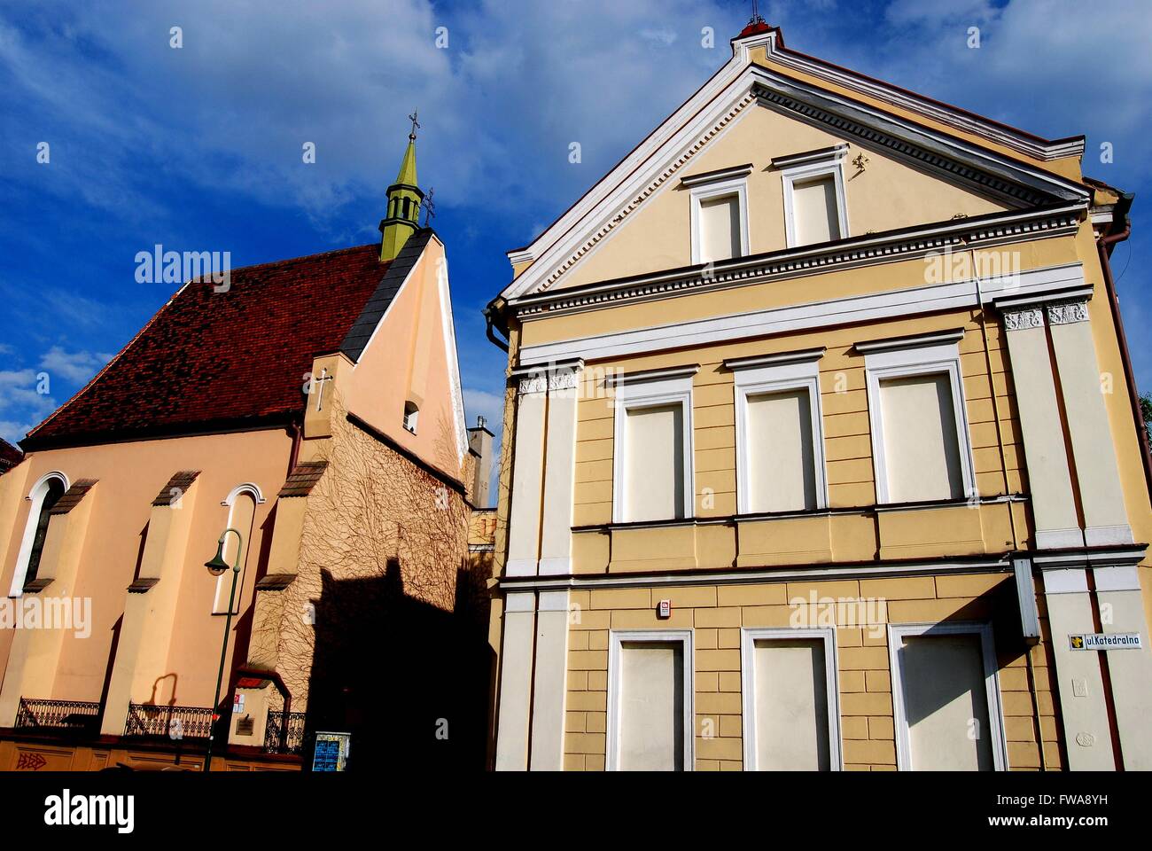 Opole, Poland:  Church of St. Sebastian (left) and  19th century neo-classical house Stock Photo