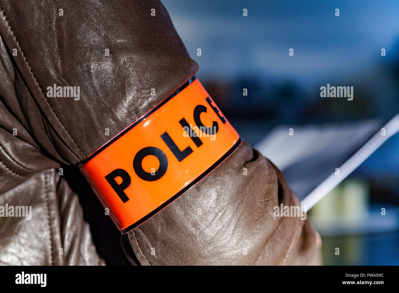 Police officer wearing a Police sign armband Stock Photo