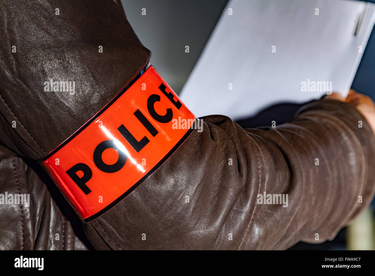 Police officer wearing a Police sign armband Stock Photo Alamy