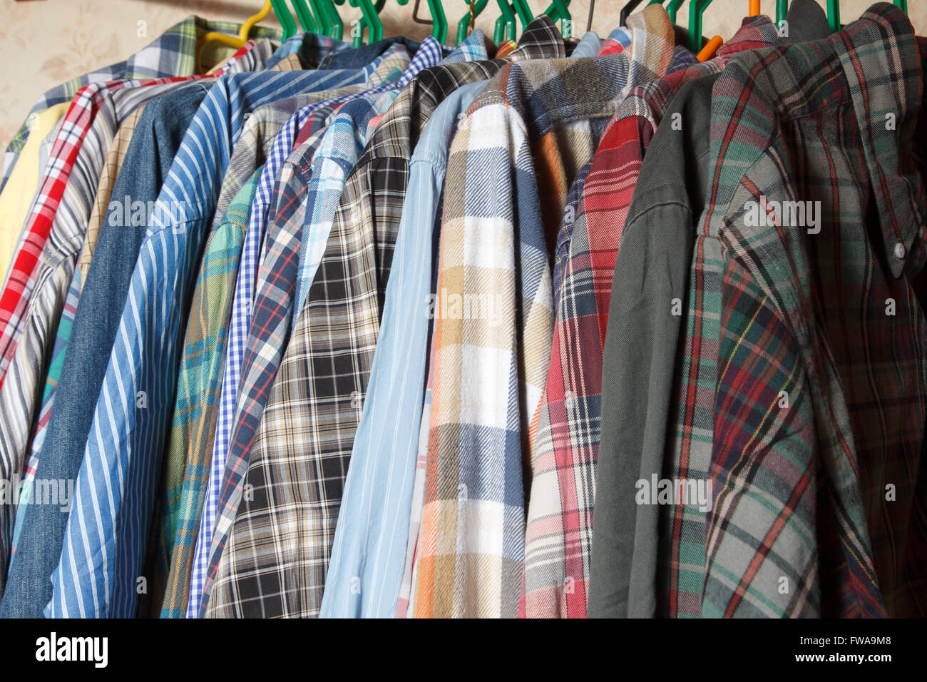 Vintage style image of male mens shirts on hangers in a shop display or  wardrobe closet rail Stock Photo - Alamy