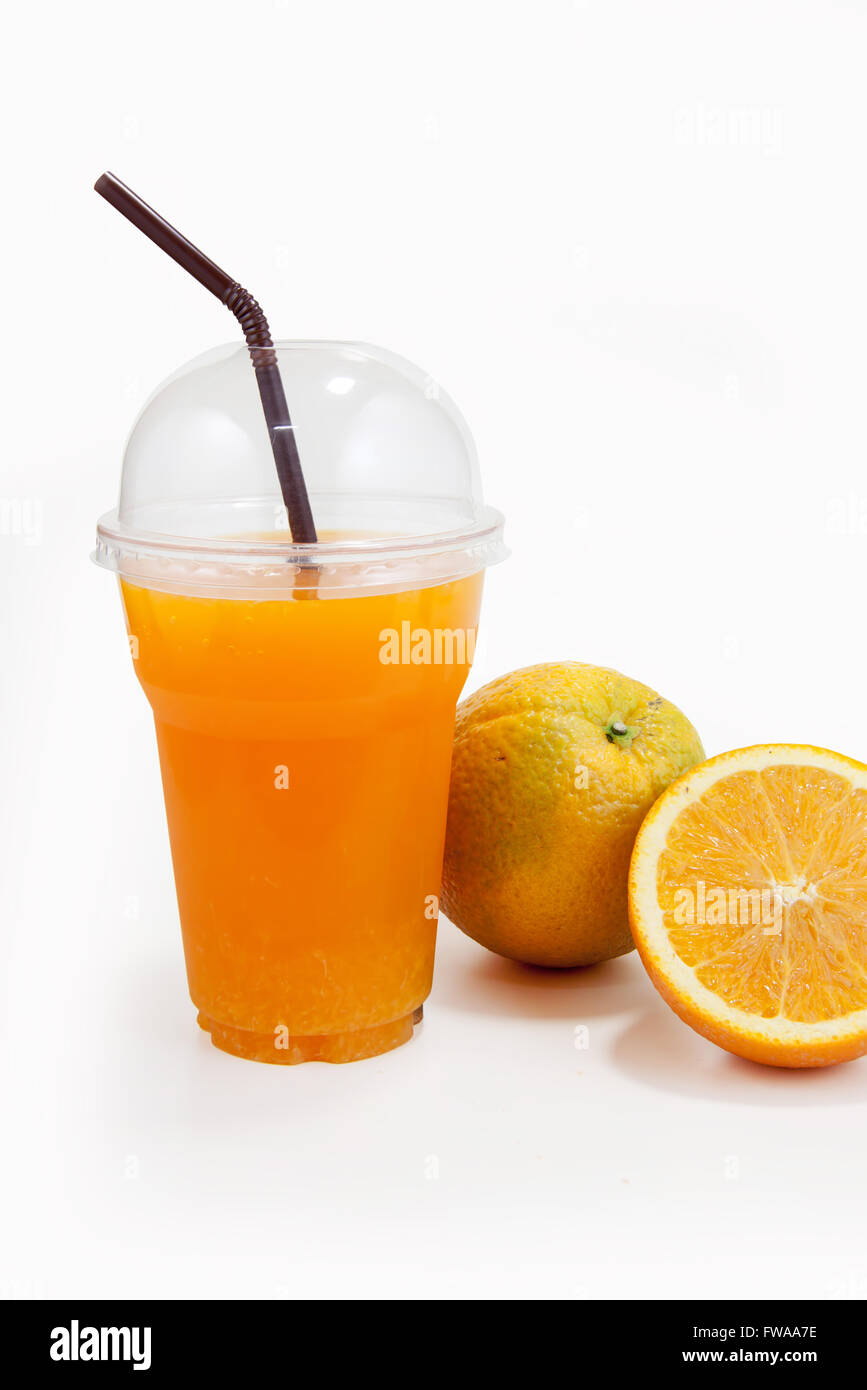 Orange juice in plastic clear cup and orange fruit on isolated white