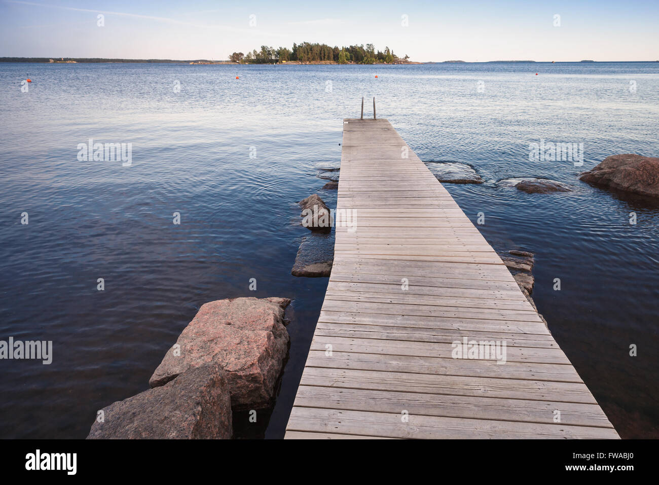 Finnish Saimaa lake landscape with wooden pier for swimming Stock Photo