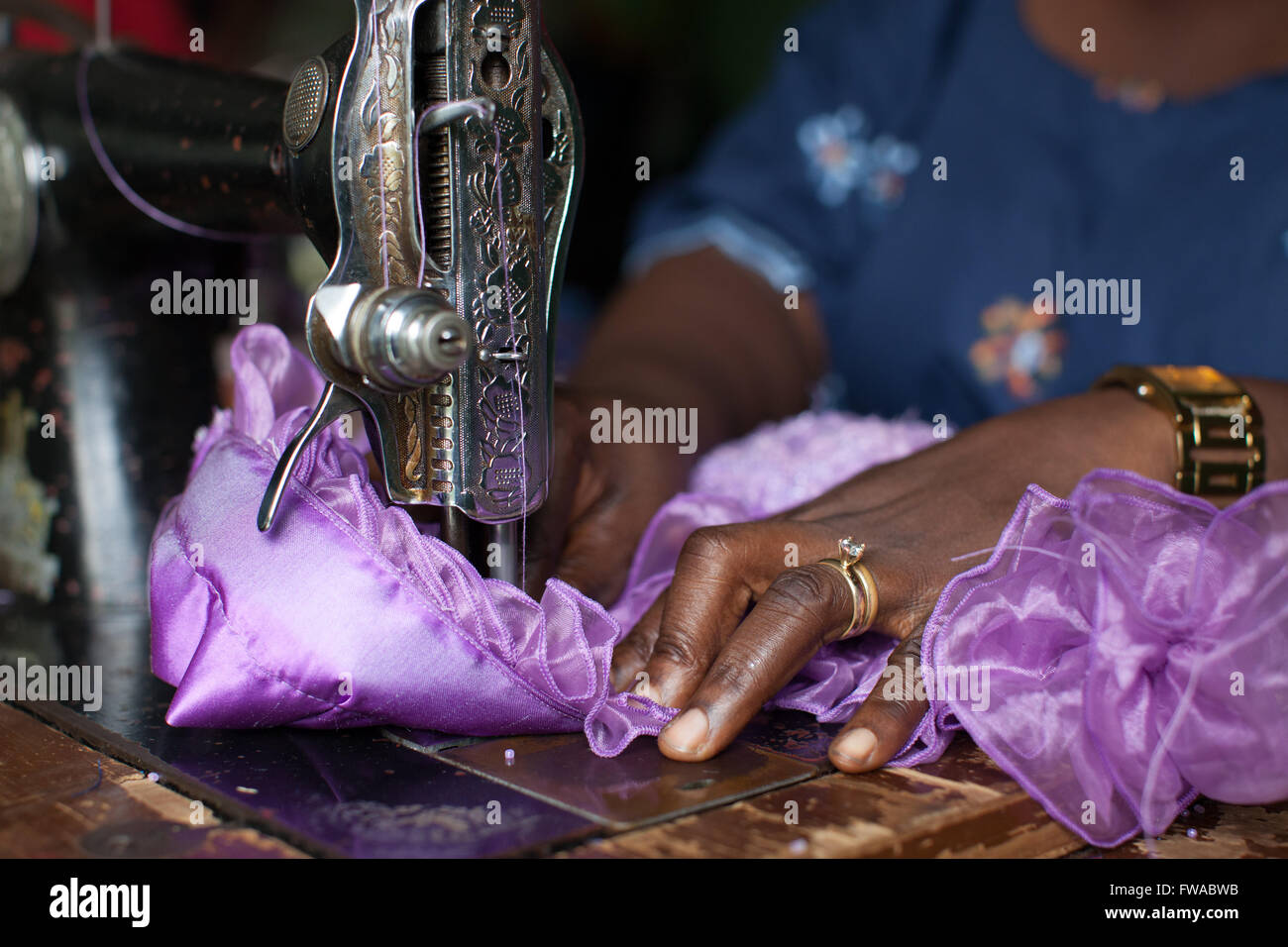 A female dress maker using a sewing machine, Nigeria, Africa Stock