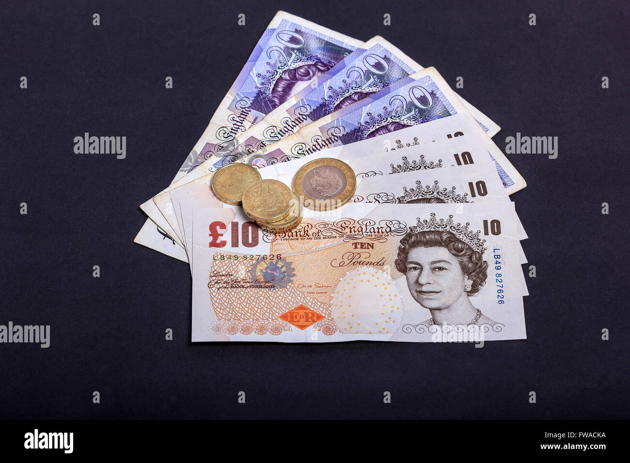 Pound notes and coins British Sterling Stock Photo